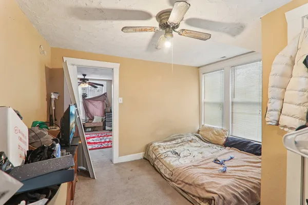 a bedroom that has a bed and a chandelier