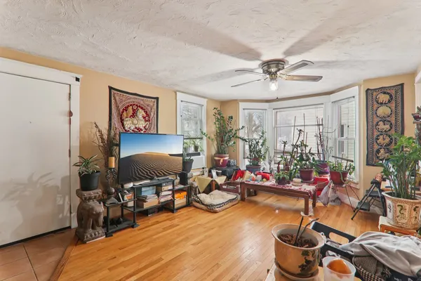 a living room with lots of furniture and paintings on the wall