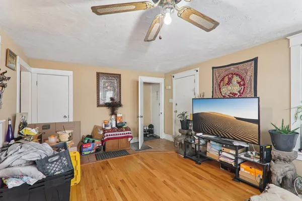 a bedroom with furniture and a flat screen tv