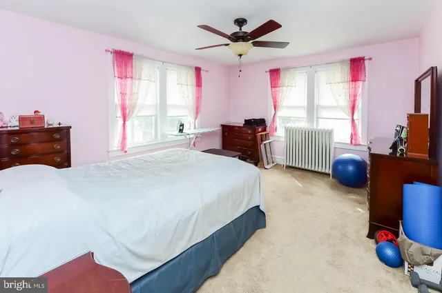 a bedroom with a bed dresser and a window