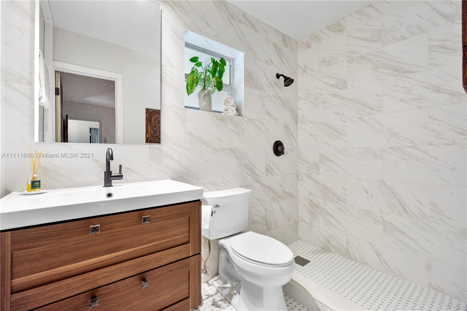 183 Oregon Lane Boca Raton, FL 33487 - Photo 18 of 25 a bathroom with a sink a toilet and shower
