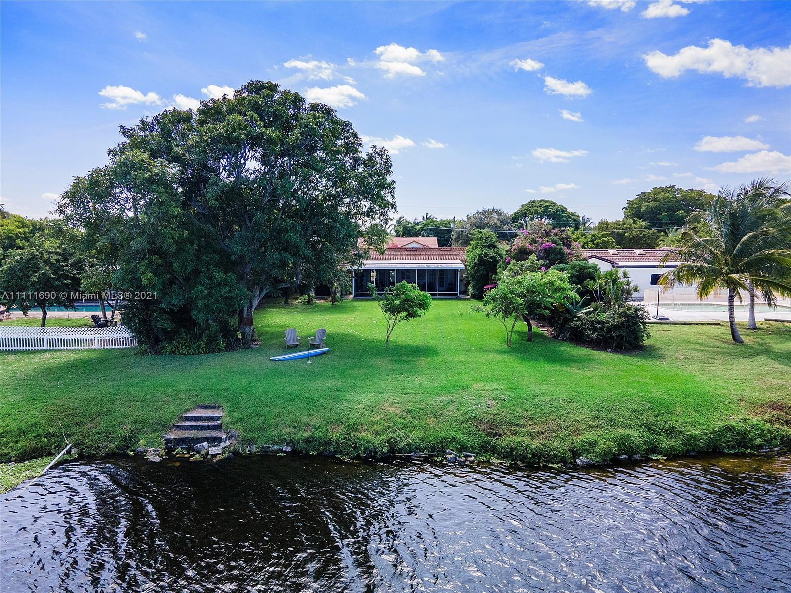 183 Oregon Lane Boca Raton, FL 33487 - Photo 21 of 25 a front view of a house with garden