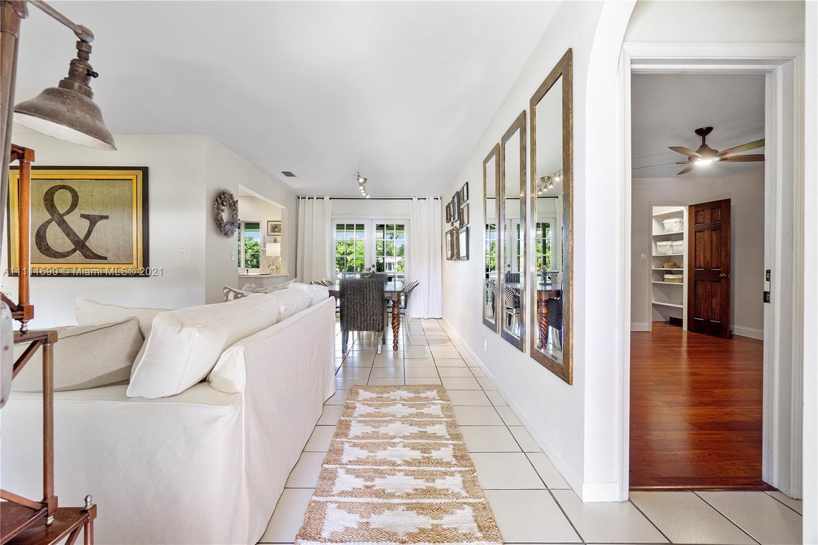 183 Oregon Lane Boca Raton, FL 33487 - Photo 6 of 25 a hallway with a large window and a fireplace