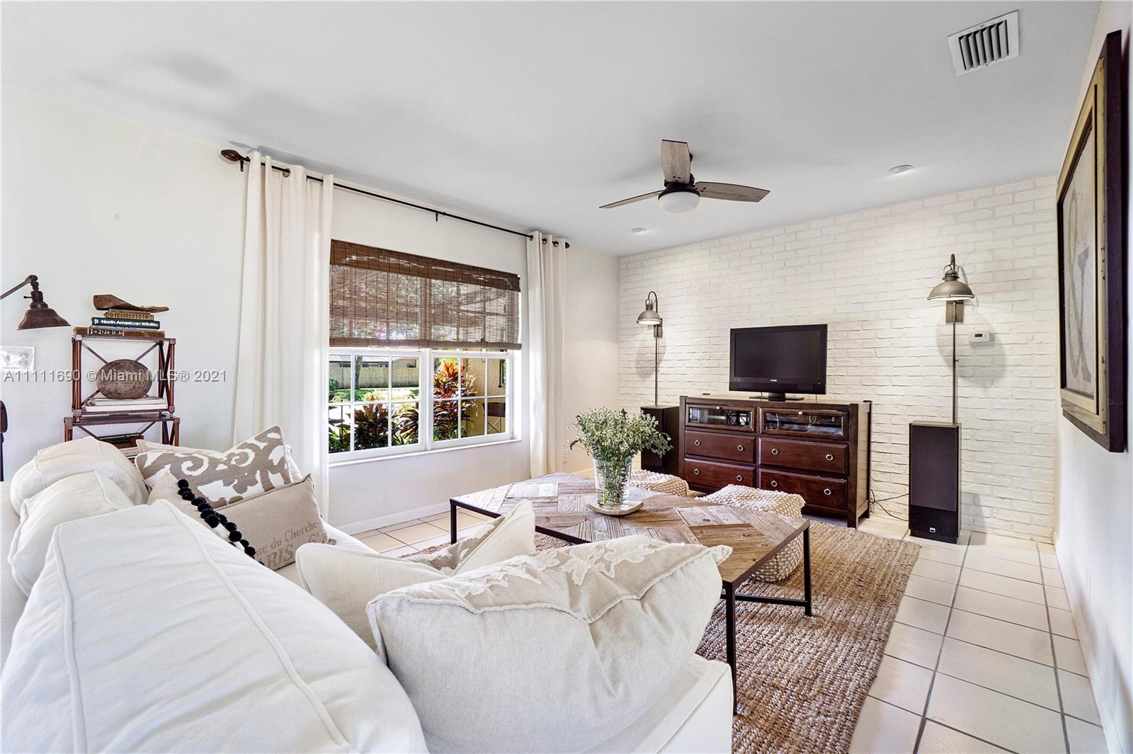 183 Oregon Lane Boca Raton, FL 33487 - Photo 7 of 25 a living room with furniture a large window and a flat screen tv