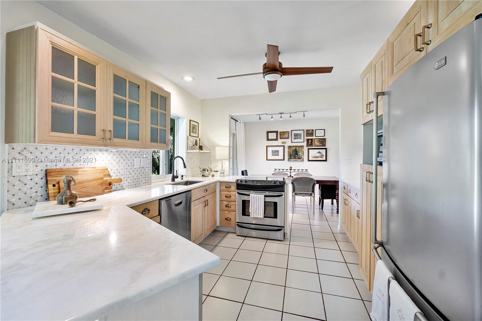 183 Oregon Lane Boca Raton, FL 33487 - Photo 10 of 25 a kitchen with stainless steel appliances granite countertop a stove a sink and a refrigerator