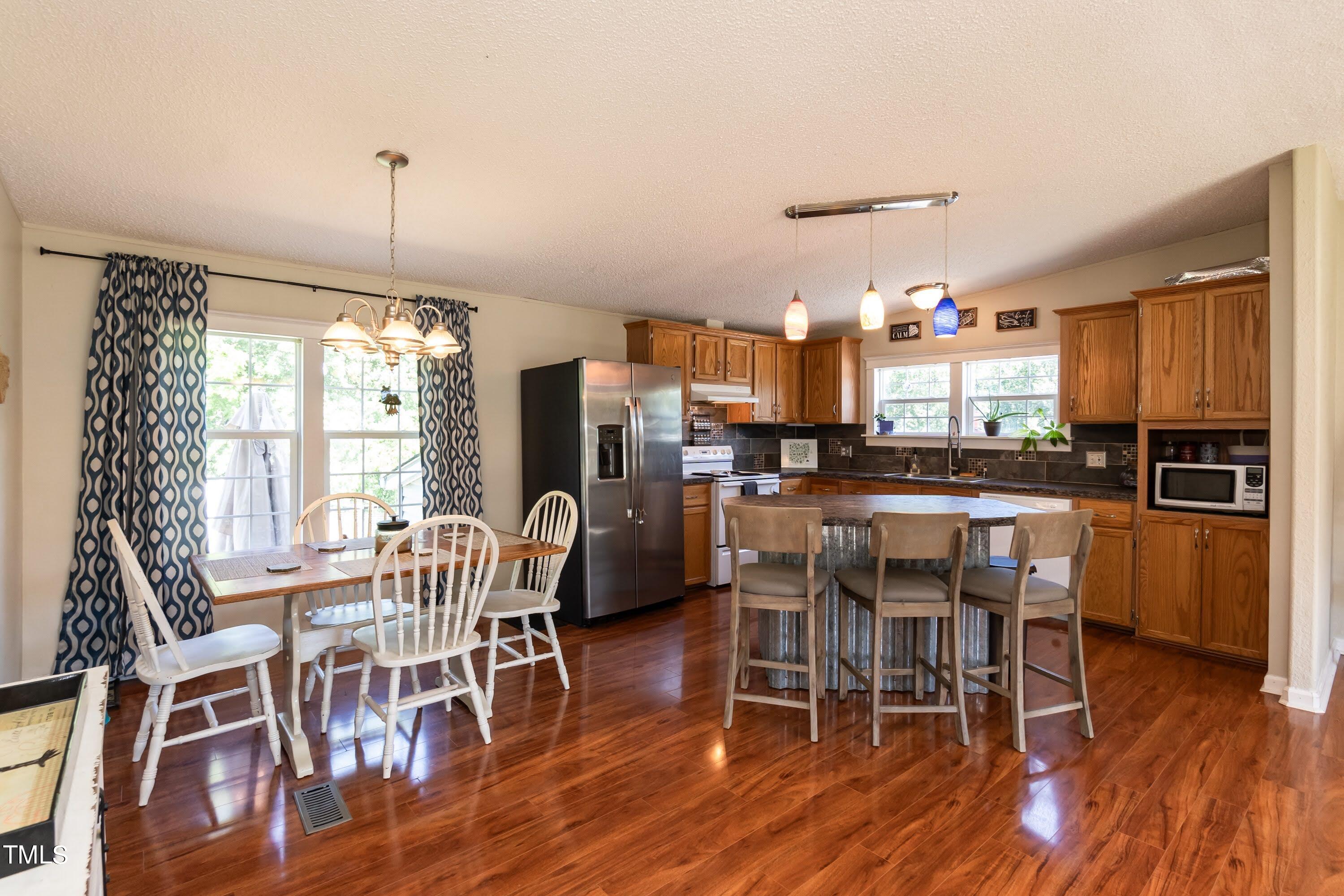 552 Locks Lane Rougemont, NC 27572 - Photo 16 of 45 a view of a dining room with furniture window and wooden floor