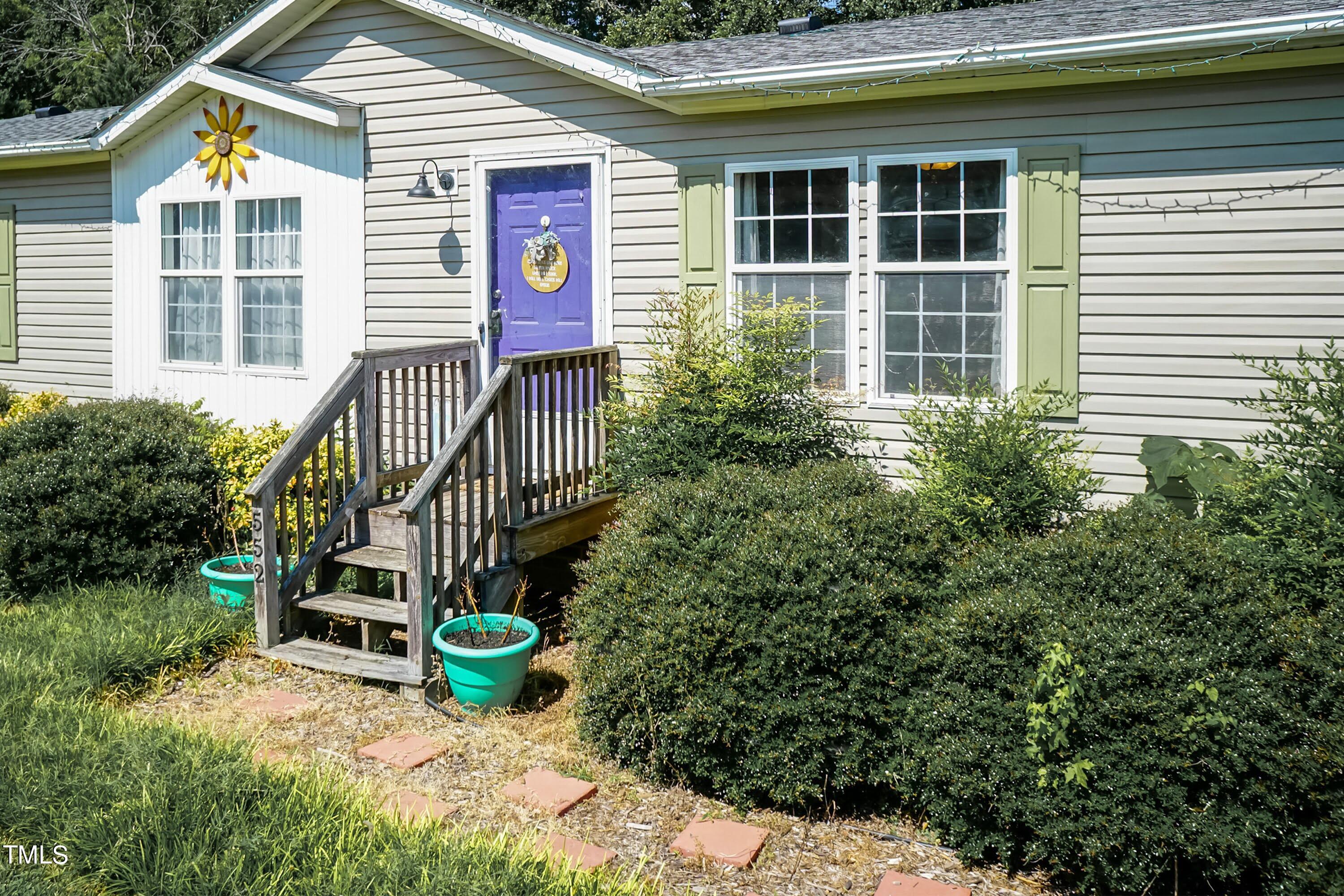 552 Locks Lane Rougemont, NC 27572 - Photo 2 of 45 a view of a house with a small yard and potted plants