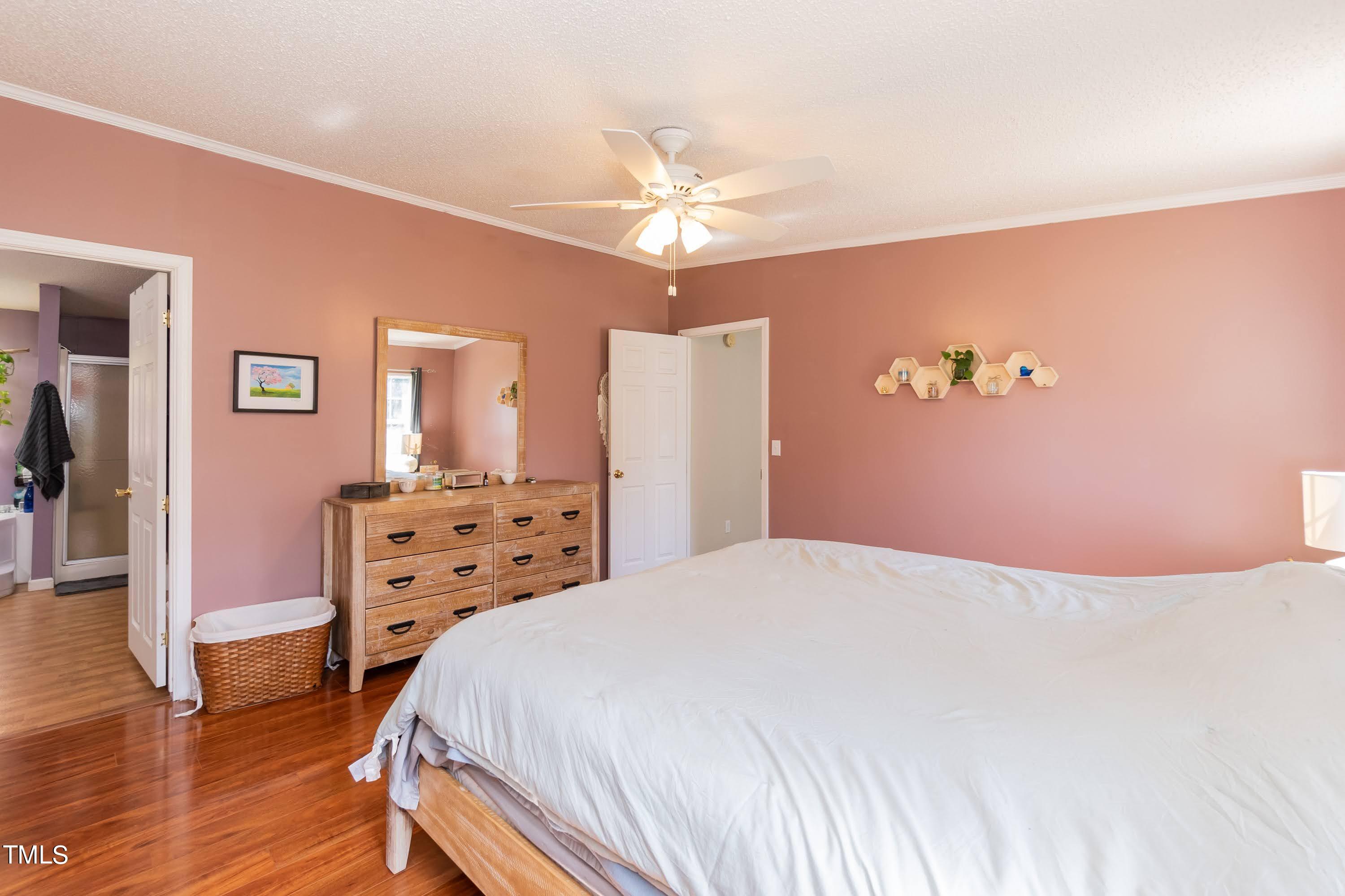 552 Locks Lane Rougemont, NC 27572 - Photo 25 of 45 a bedroom with a bed and wooden floor