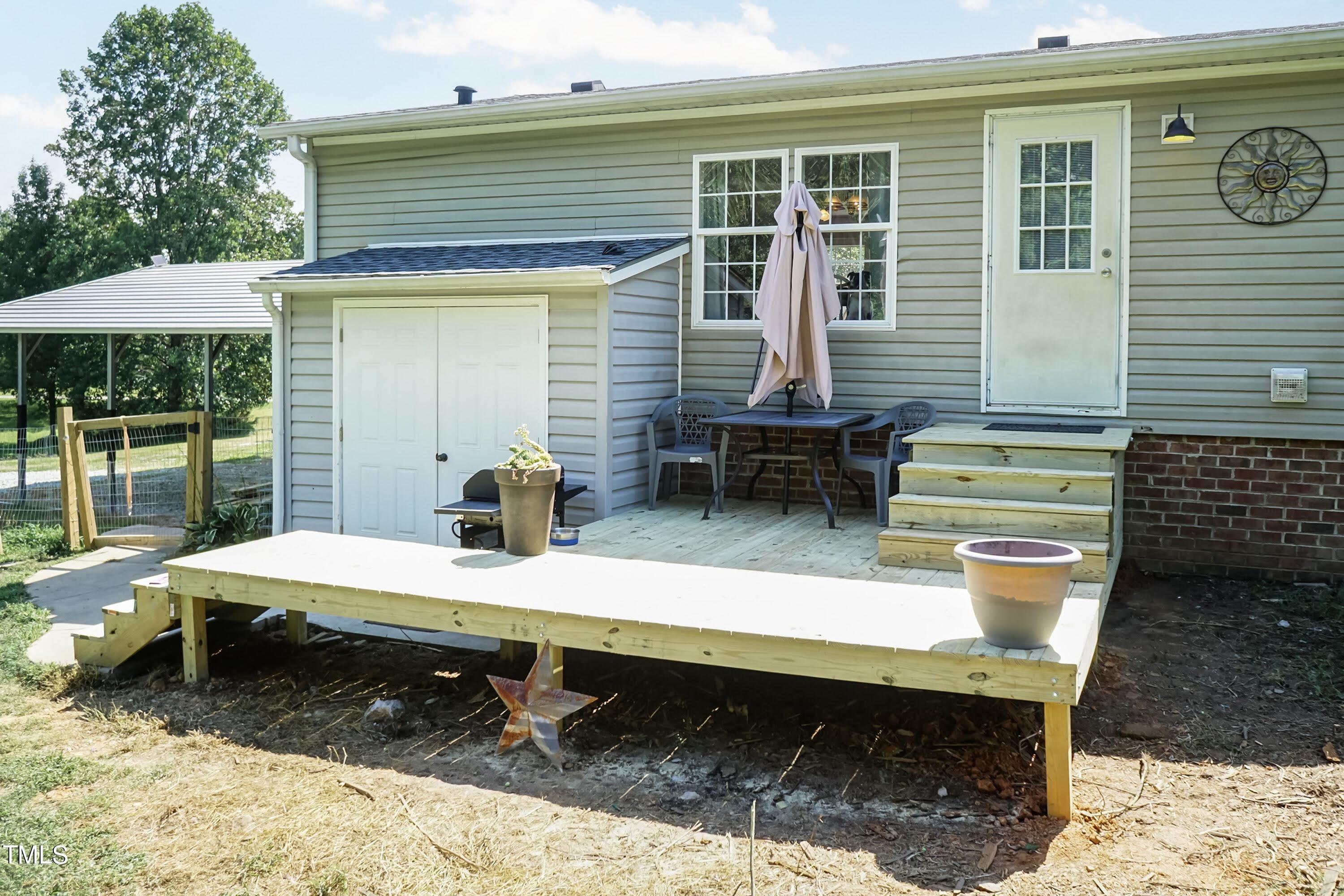 552 Locks Lane Rougemont, NC 27572 - Photo 33 of 45 a backyard of a house with barbeque oven table and chairs