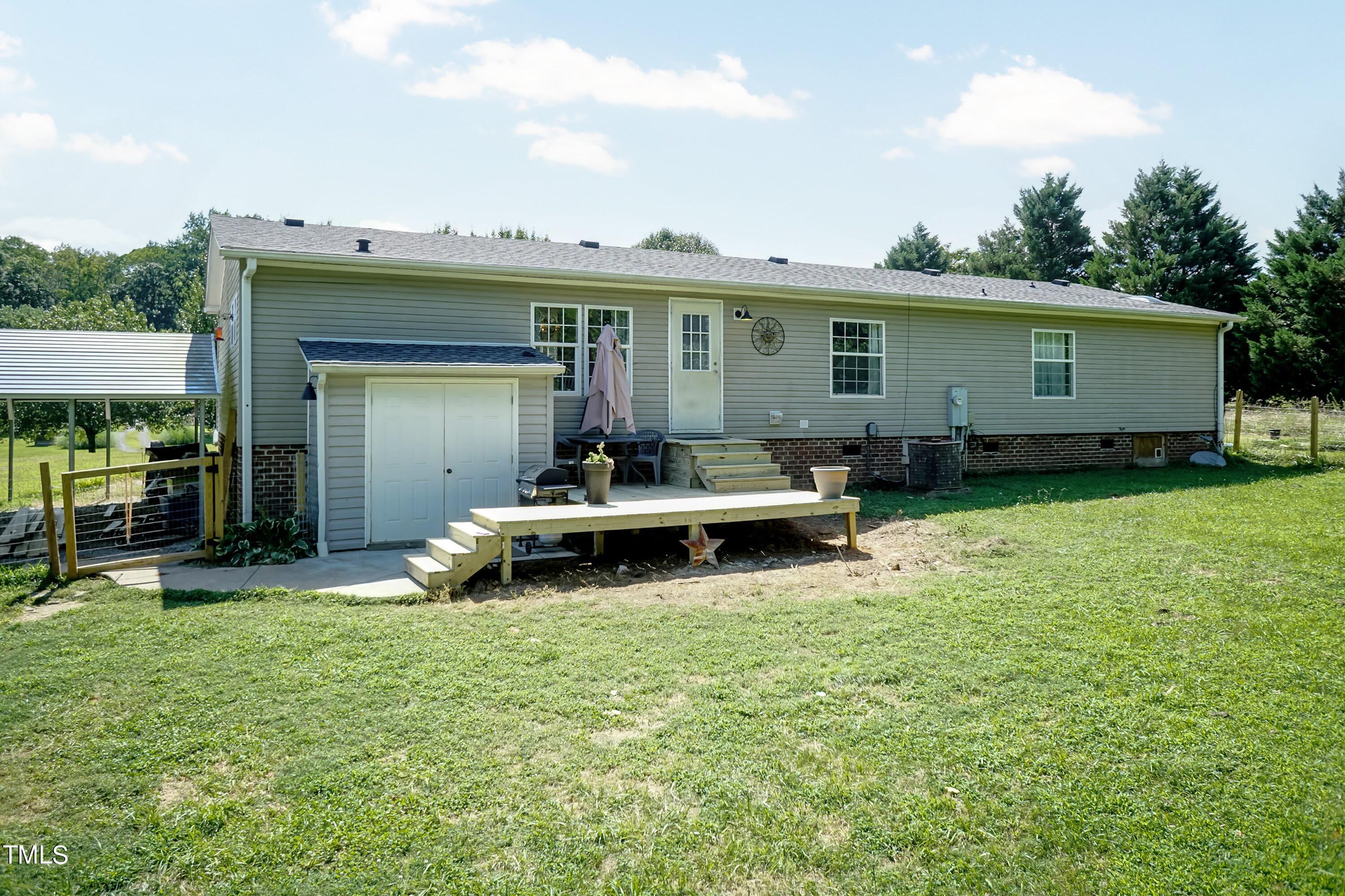 552 Locks Lane Rougemont, NC 27572 - Photo 35 of 45 a view of a house with backyard sitting area and garden