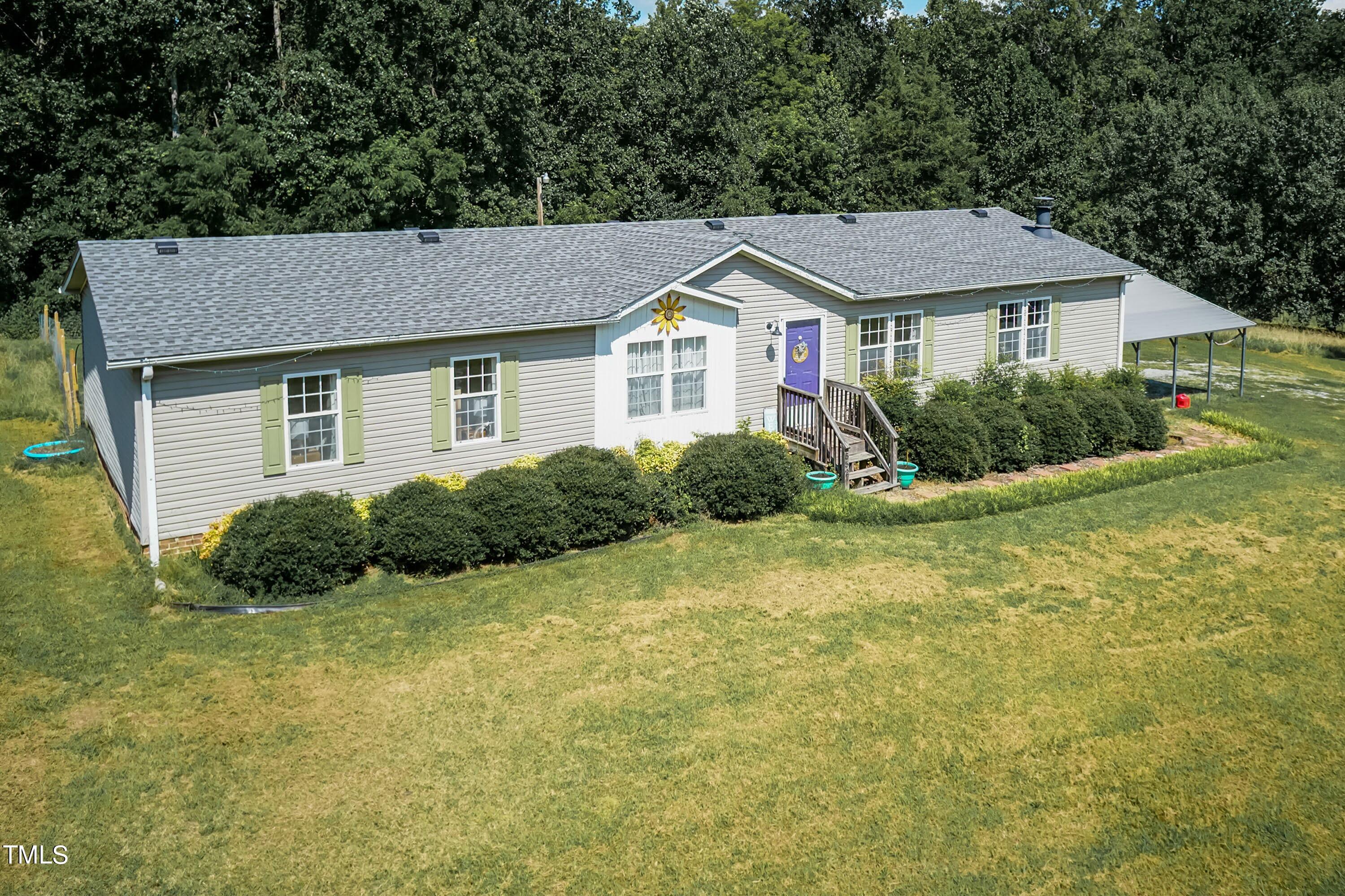 552 Locks Lane Rougemont, NC 27572 - Photo 5 of 45 a front view of a house with a yard