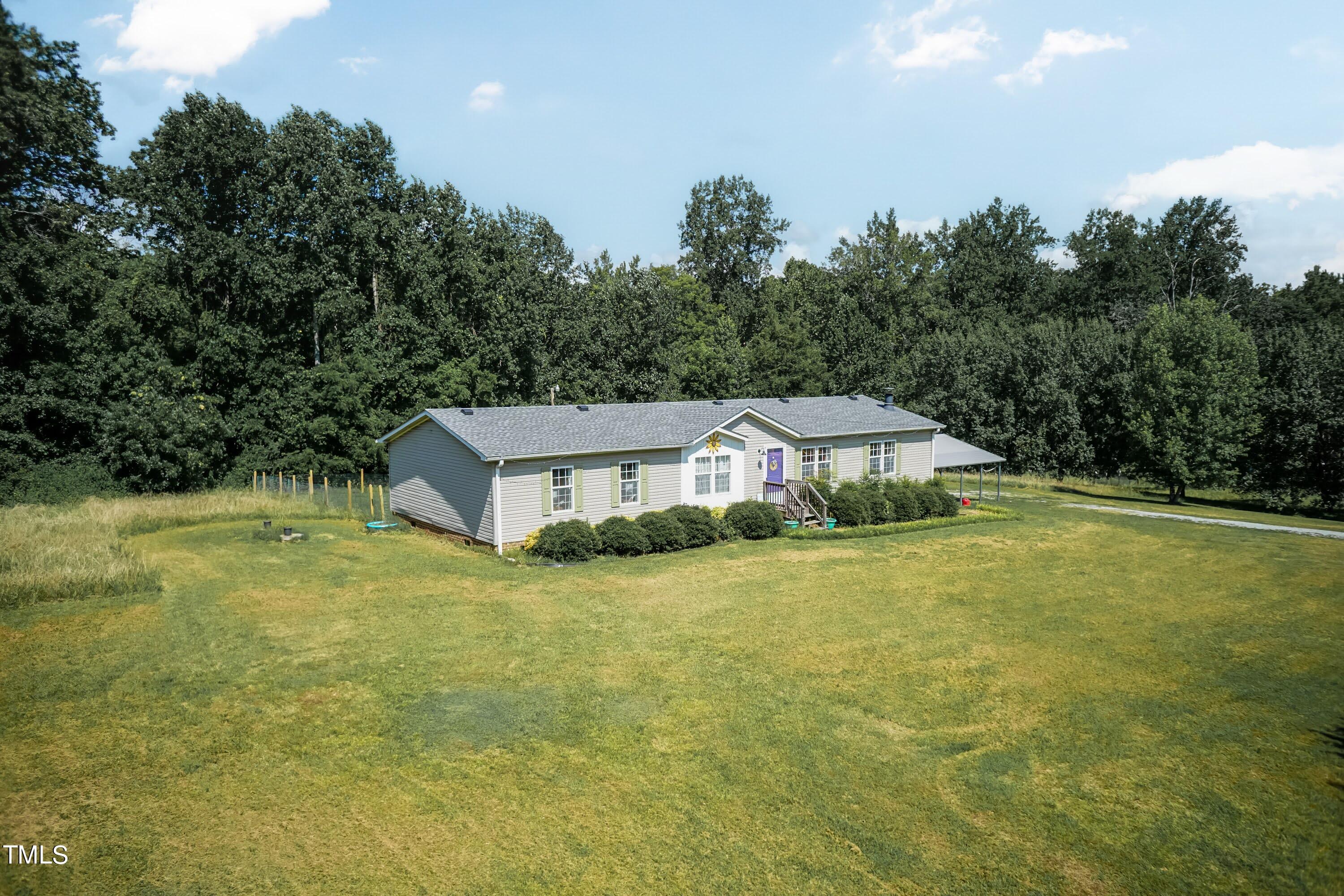 552 Locks Lane Rougemont, NC 27572 - Photo 6 of 45 a front view of a house with a yard and trees