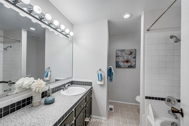 a bathroom with double vanity and a mirror