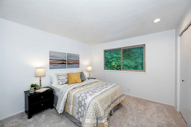 a bedroom with a bed and window