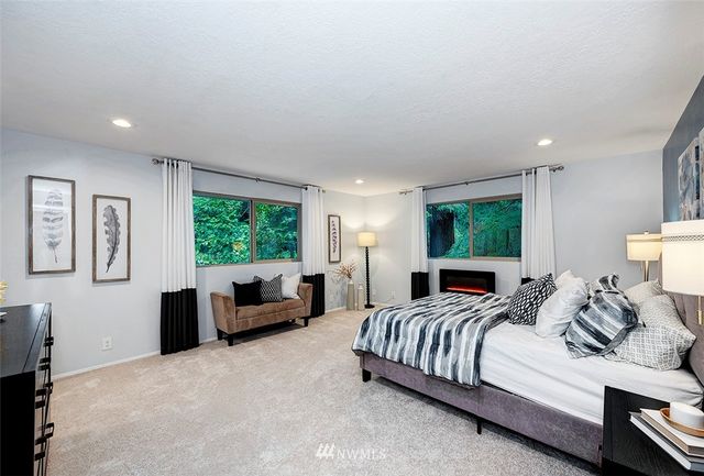 a large bedroom with a bed and a couch