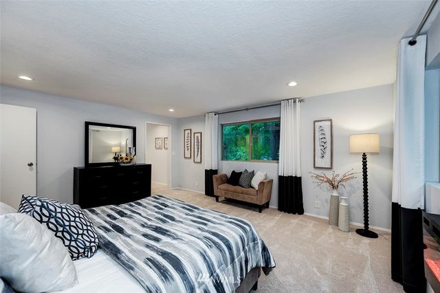 a bedroom with a bed and a couch