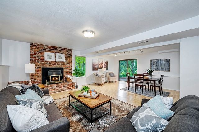 a living room with furniture a fireplace and a window