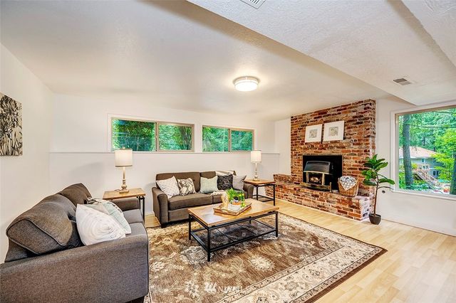 a living room with furniture a fireplace and a table