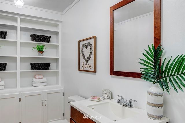 a bathroom with a sink a toilet and mirror