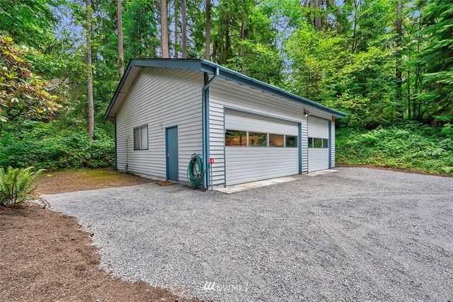 a view of a house with a yard and garage