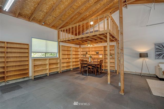a view of a room with chairs and table