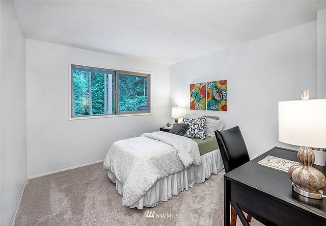 a bedroom with a bed and a desk