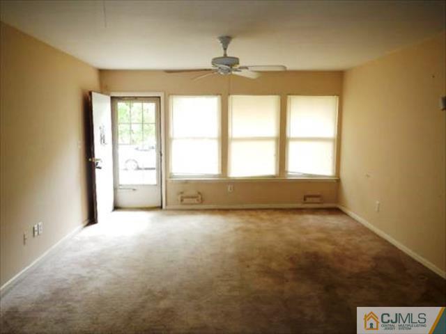 20 New Road, Unit 7A Kendall Park, NJ 08824 - Photo 2 of 4 an empty room with a empty space and a window