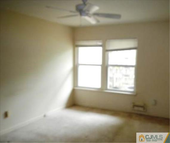 20 New Road, Unit 7A Kendall Park, NJ 08824 - Photo 3 of 4 an empty room with a window