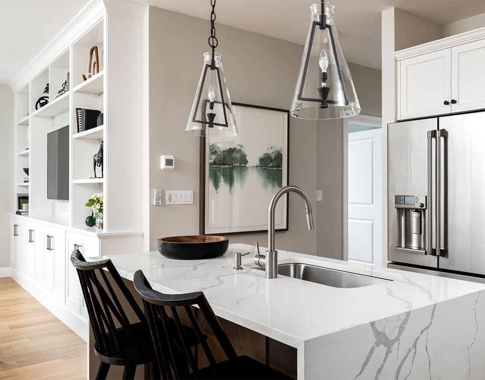 50 Coppersmith Way, Unit 107 Canton, MA 02021 - Photo 14 of 42 a view of a dining room with furniture and a chandelier