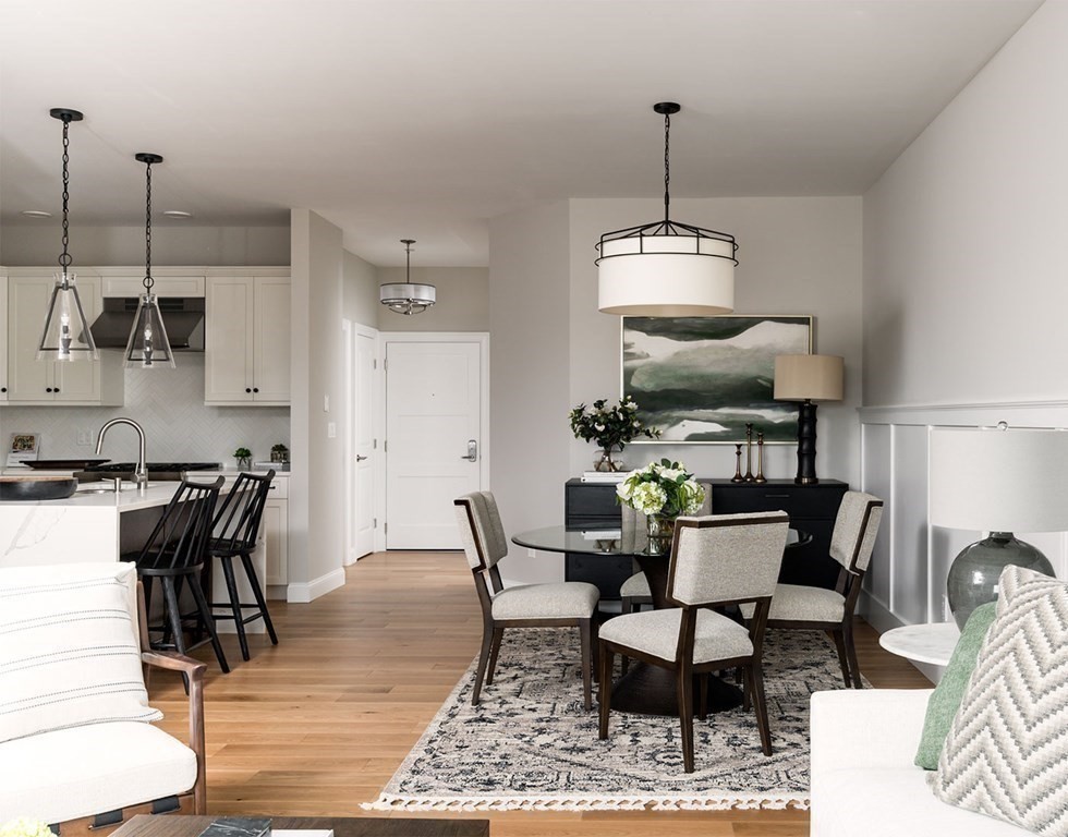 50 Coppersmith Way, Unit 107 Canton, MA 02021 - Photo 22 of 42 a dining room with furniture and wooden floor