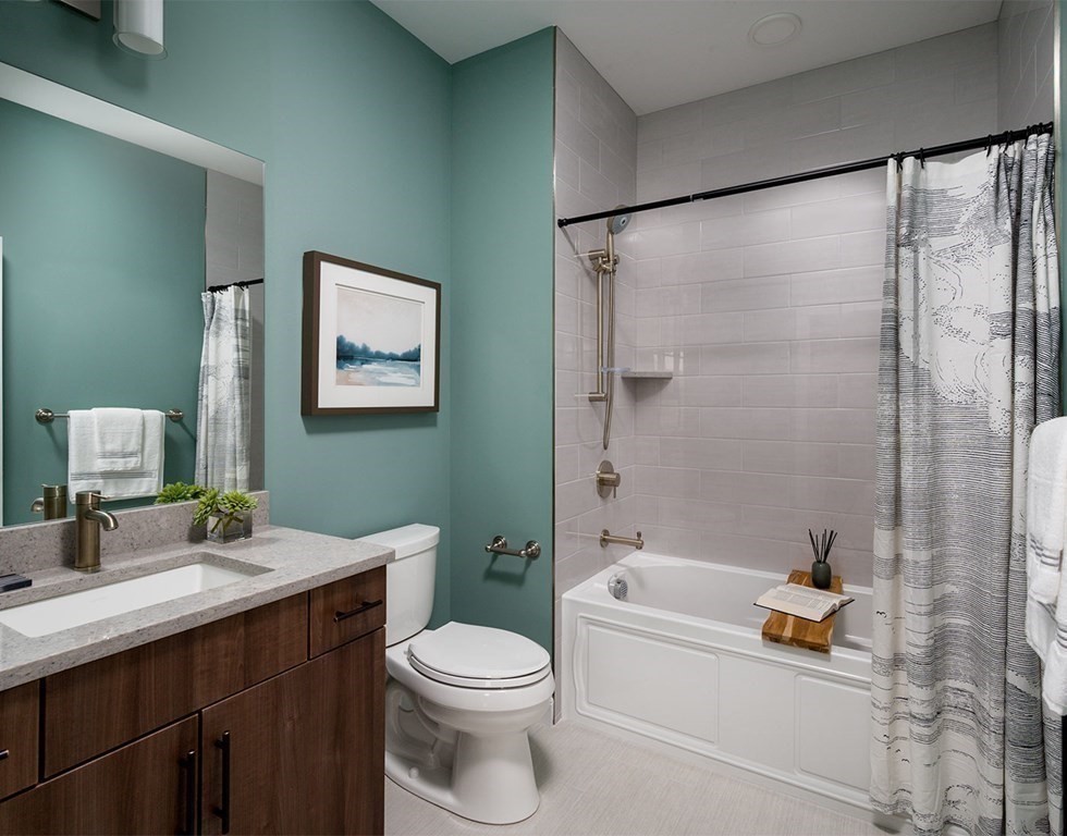 50 Coppersmith Way, Unit 107 Canton, MA 02021 - Photo 25 of 42 a bathroom with a sink mirror vanity and toilet