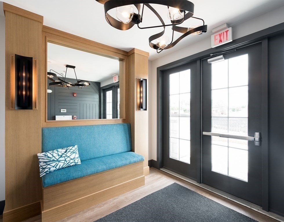 50 Coppersmith Way, Unit 107 Canton, MA 02021 - Photo 28 of 42 a living room with furniture and a large window