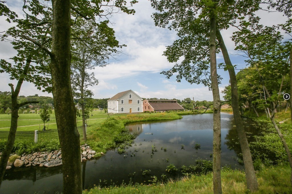 50 Coppersmith Way, Unit 107 Canton, MA 02021 - Photo 3 of 42 a view of a lake with houses