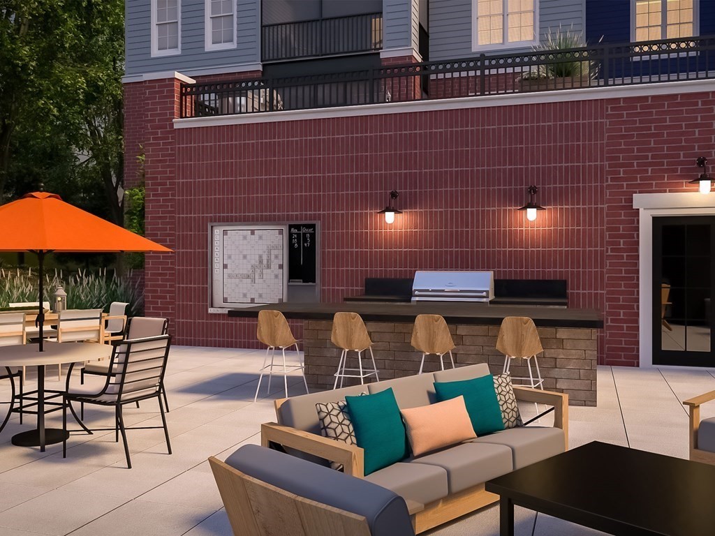 50 Coppersmith Way, Unit 107 Canton, MA 02021 - Photo 42 of 42 a outdoor space with patio the couches and umbrella