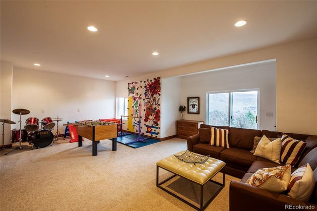 a living room with furniture a flat screen tv and a large window