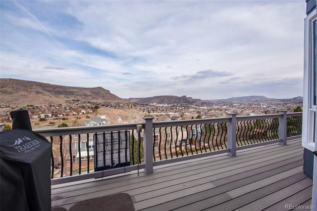 a view of a balcony with wooden floor and city view