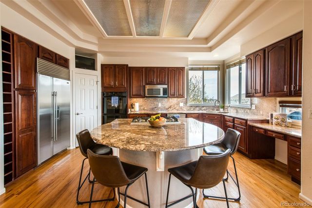 a kitchen with granite countertop a dining table chairs and granite counter tops