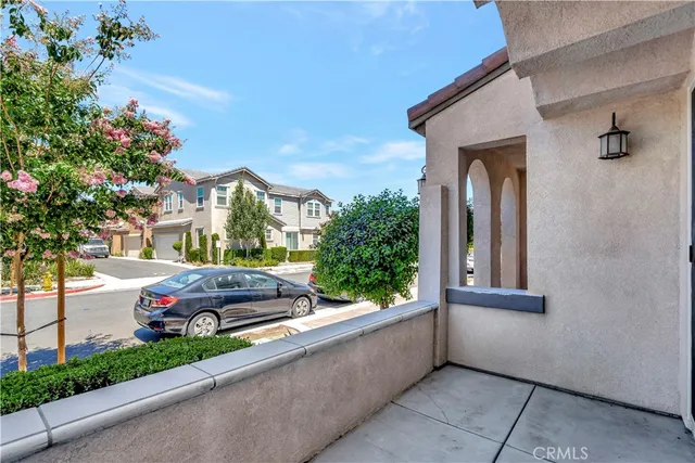 a view of large kitchen with granite countertop a large counter top stainless steel appliances and windows