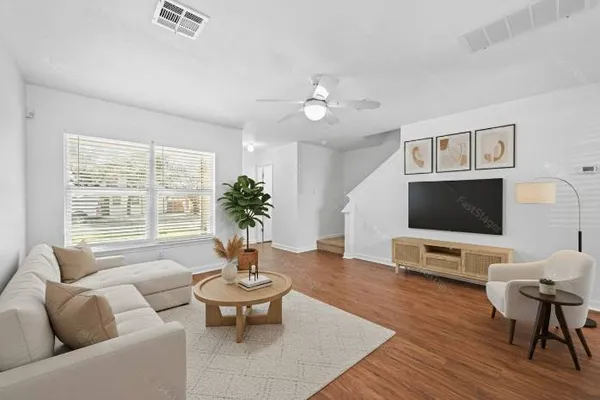 a living room with furniture and a flat screen tv