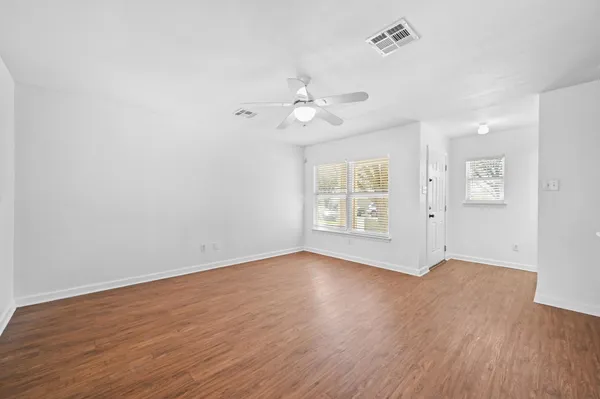 wooden floor in an empty room with a window
