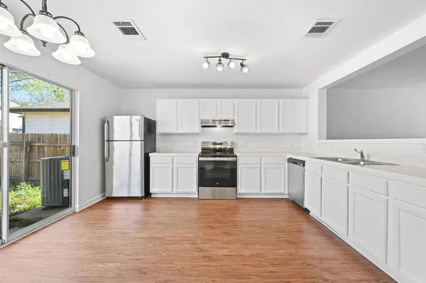 a kitchen with stainless steel appliances a refrigerator sink and cabinets