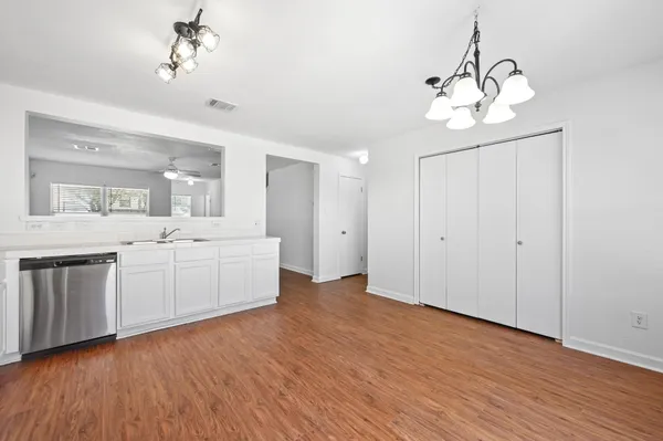 a view of a kitchen with a dishwasher cabinets and wooden floor