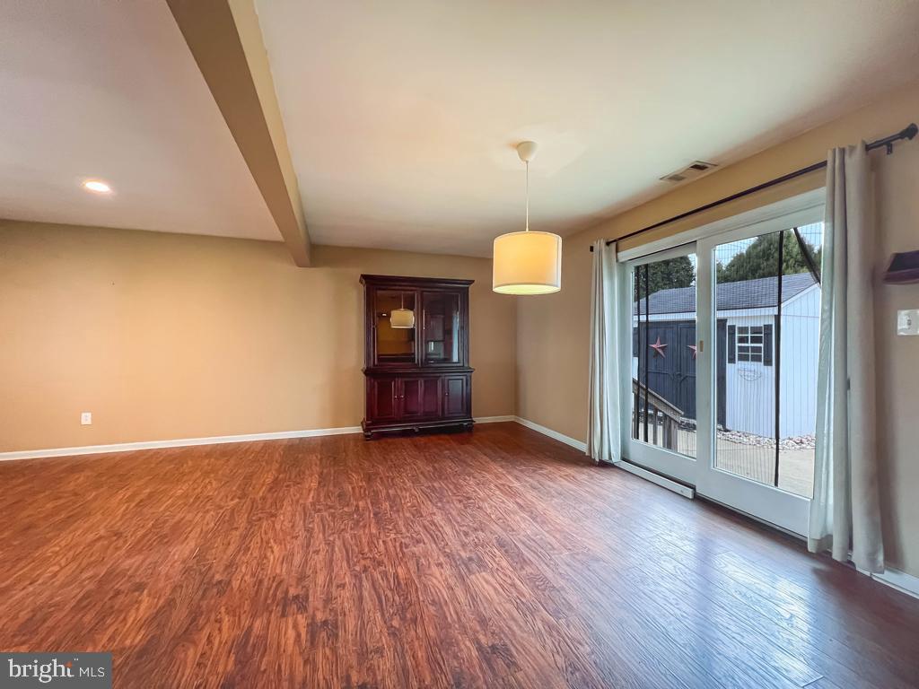 599 Panther Road Warminster, PA 18974 - Photo 11 of 57 an empty room with wooden floor and windows
