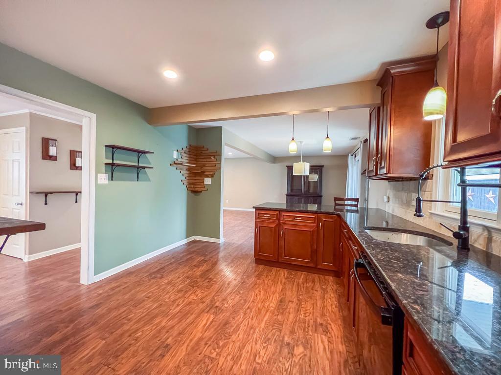 599 Panther Road Warminster, PA 18974 - Photo 13 of 57 a kitchen with stainless steel appliances granite countertop a sink a stove top oven a counter space and cabinets
