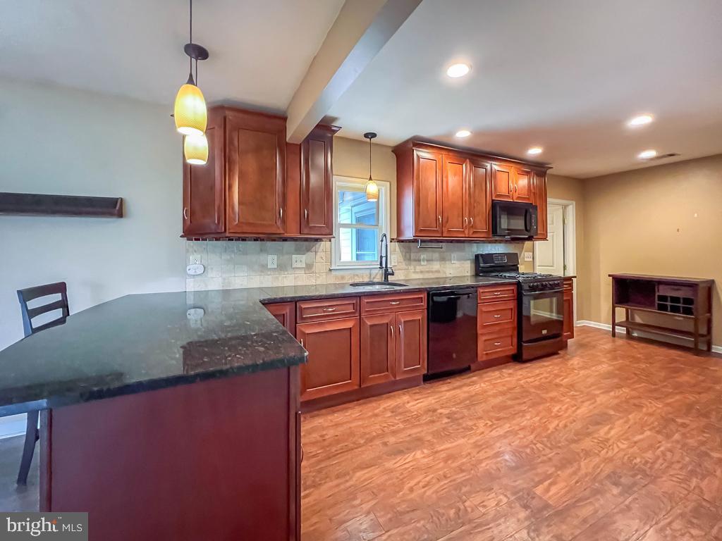 599 Panther Road Warminster, PA 18974 - Photo 14 of 57 a kitchen with stainless steel appliances granite countertop a sink a stove counter space and cabinets