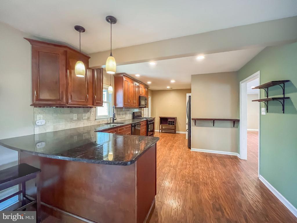 599 Panther Road Warminster, PA 18974 - Photo 15 of 57 a kitchen with stainless steel appliances granite countertop a refrigerator a sink and a stove