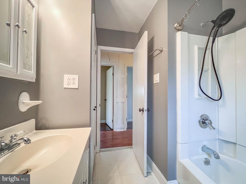 599 Panther Road Warminster, PA 18974 - Photo 19 of 57 a bathroom with a granite countertop shower a sink and a mirror