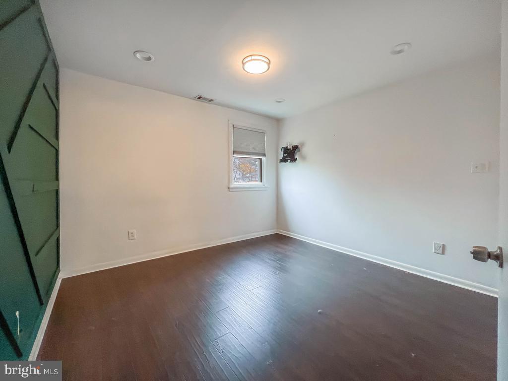 599 Panther Road Warminster, PA 18974 - Photo 22 of 57 an empty room with wooden floor and windows