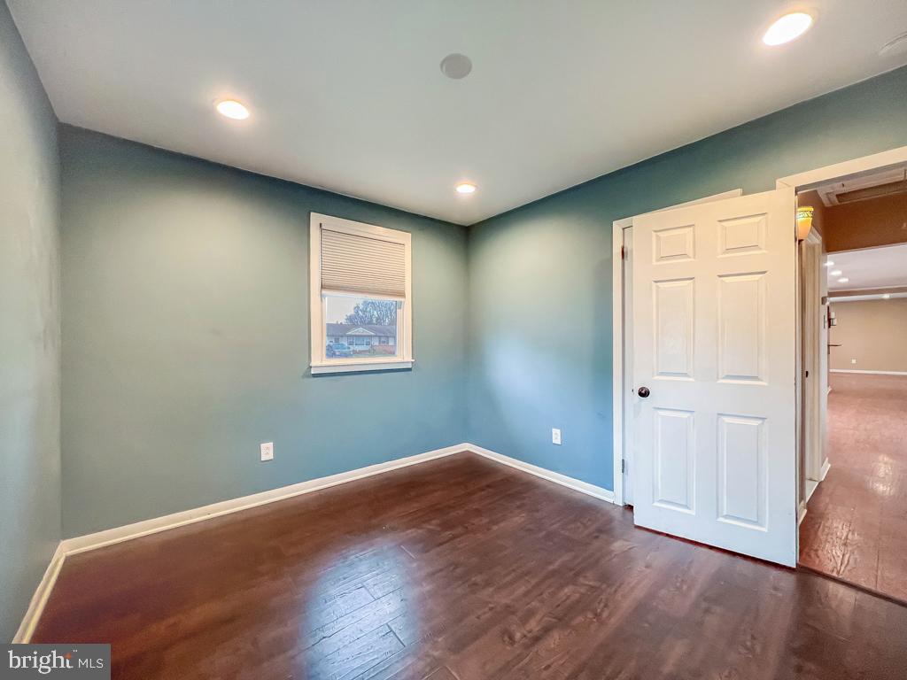 599 Panther Road Warminster, PA 18974 - Photo 28 of 57 an empty room with wooden floor and windows