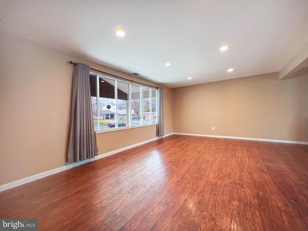 599 Panther Road Warminster, PA 18974 - Photo 32 of 57 a view of an empty room with wooden floor and a window